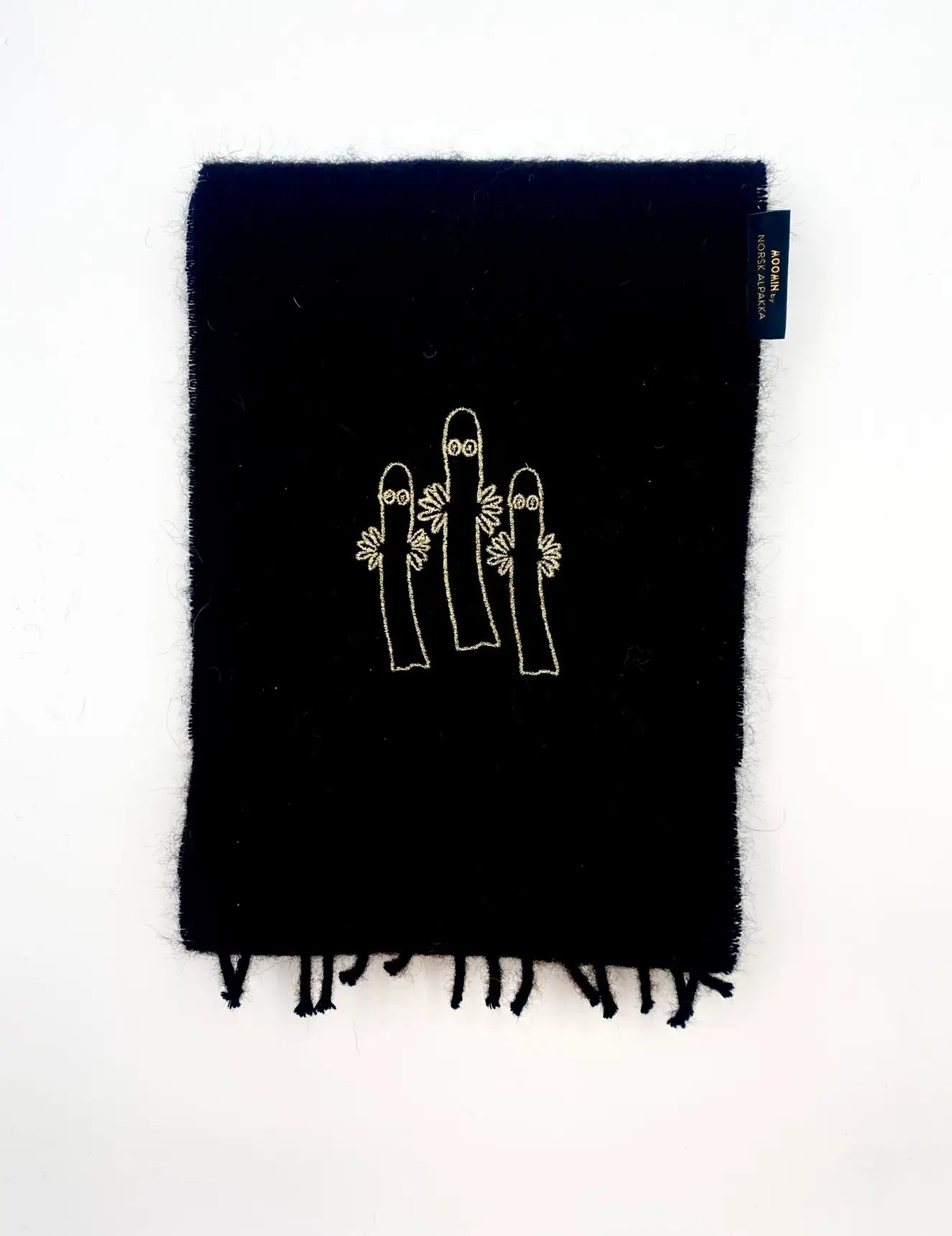 Natural Black alpaca scarf with gold Moomin Hattifatter embroidery, crafted in Sigdal by Norsk Alpakka.